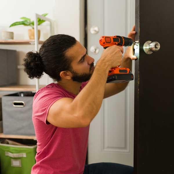 repair-man-fixing-door